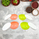 Top view of four small plastic bowls with lids, ready for use.