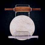 Elegant stainless steel stand securely holding a wooden rolling pin on a kitchen counter.