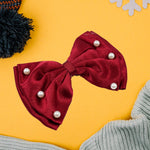 Detailed view of the heart-shaped design on the girls' hair bow clip.