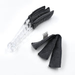 The compact blind cleaner brush being used to clean dust from a car's AC vent.