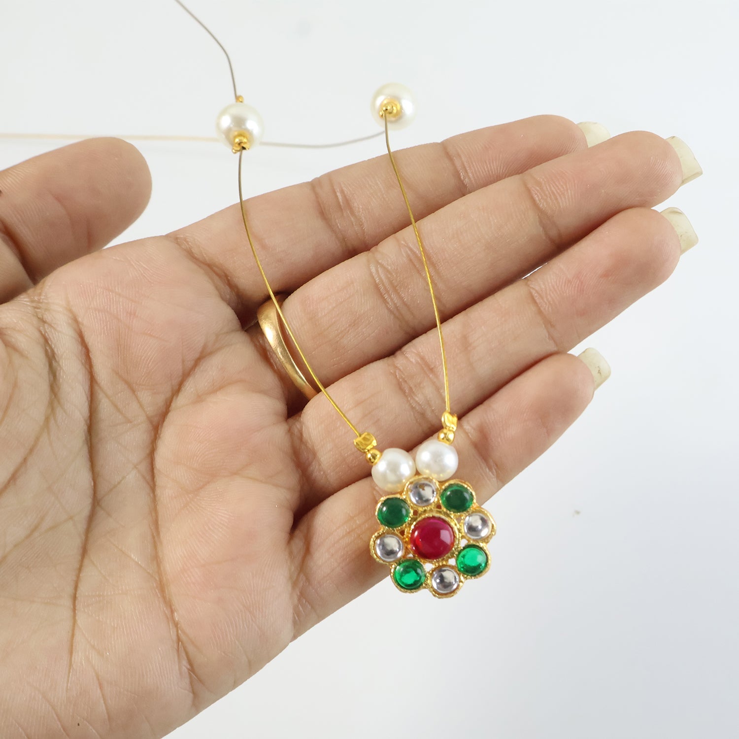 Delicate gold-tone necklace with vibrant multicolor floral pendant and pearl accents