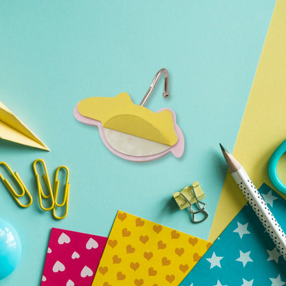 A cute bear-shaped self-adhesive hook on a wall, showcasing its strong adhesive backing for easy application.