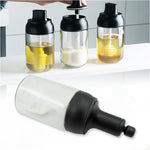 A Heat-Resistant Glass Seasoning Jar with integrated spoon, perfect for kitchen use.