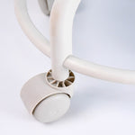 Side view of low rolling stool showing cushioned seat and sturdy wheels
