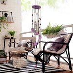 Side view of the handcrafted bamboo and aluminium wind chime with heart accents.