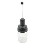 The sleek design of the Heat-Resistant Glass Seasoning Jar on a kitchen counter.