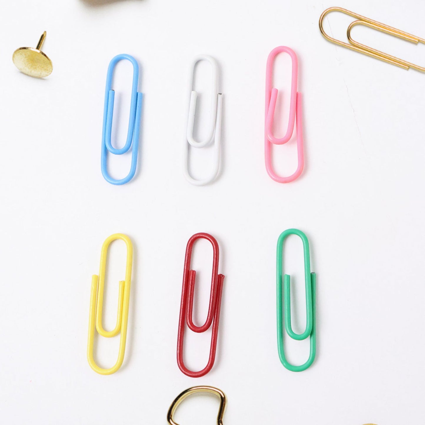 Close-up of multicolor office paper clips holding papers securely