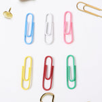 Close-up of multicolor office paper clips holding papers securely