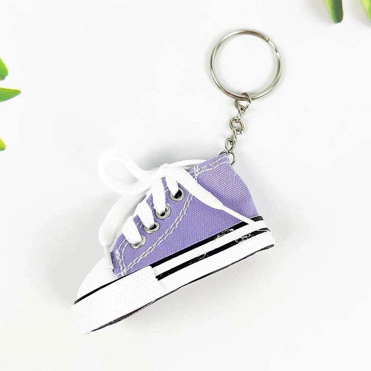 Miniature high-top basketball shoe keychain with black laces.