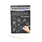 Child drawing detailed doodle on colorful scratch art sheet