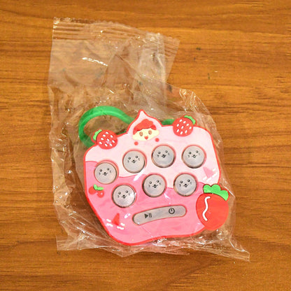 Side view of lightweight strawberry push button keychain fidget toy