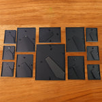 Premium matte black plastic photo frames arranged in a 12-piece set