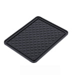 Universal anti-skid mat preventing items from sliding on a smooth table surface.