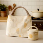 Insulated lunch bag filled with a tiffin box and a water bottle, ready for a meal.