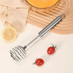 Egg beater whisk whipping ingredients in kitchen