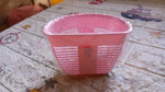 Lifestyle shot of the storage basket in use, holding various household items.