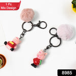 Kawaii cartoon keychain attached to bag featuring a soft fluffy pom pom