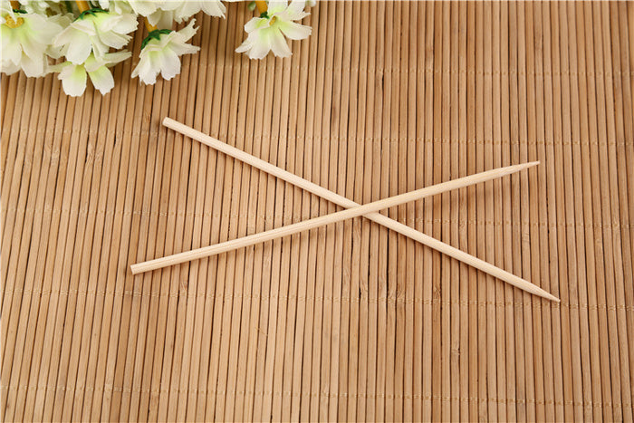 Bundle of natural bamboo skewers tied with string for display.