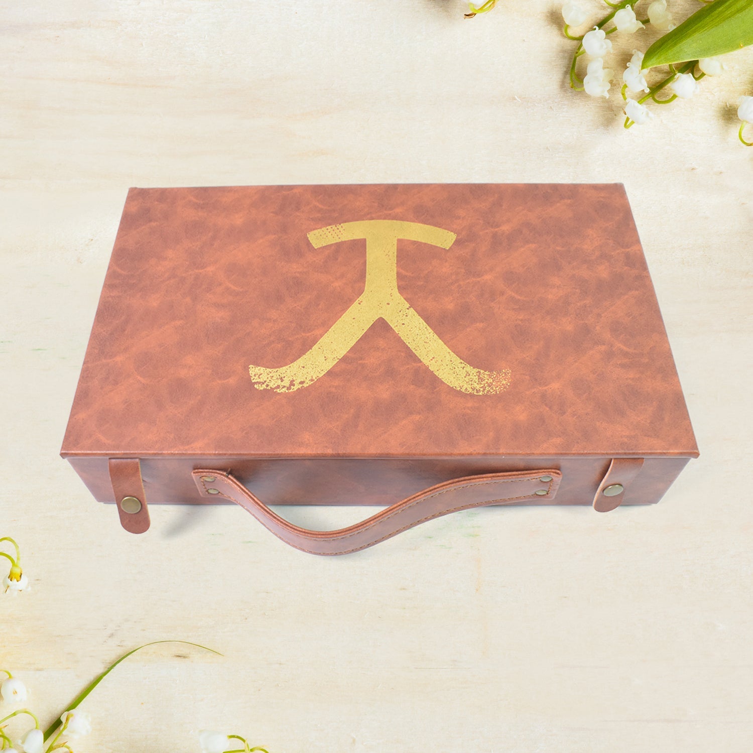 Stylish leather carrying case being held, demonstrating its portability and elegant appeal.