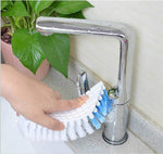 Flexible cleaning brush positioned to clean a bathroom faucet.