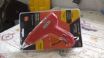 Packaging for the professional hot melt glue gun, indicating its power and contents.