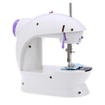 Close-up of the mini sewing machine's needle and thread for fabric stitching.