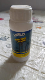 Drain cleaning powder effectively removing blockages from a kitchen sink.