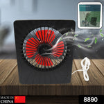 Compact portable desk fan on a wooden table, powered by USB for versatile use.