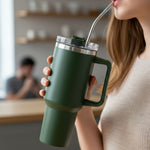 Close-up view of insulated travel mug with spill-resistant lid and reusable straw