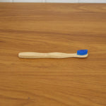 Wooden toothbrush in natural setting, eco-friendly material