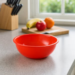Stacked plastic red bowls showcasing lightweight design
