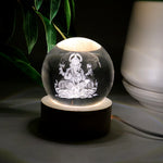 Detailed view of the illuminated 3D Ganpati idol inside the crystal ball, showing its radiant effect.