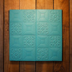 Stack of cyan colored 3D foam wallpaper tiles