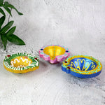 Assorted hand-painted clay diya set showcasing vibrant colors and artistic finish