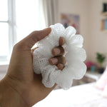 White mesh hair scrunchie adding volume and texture to styled hair