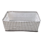 A minimalist-designed foldable canvas storage basket filled with soft linens, enhancing room aesthetics.
