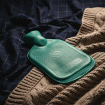 Detailed close-up view of the hot water bottle's stopper and textured surface