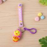 Cartoon duck key ring showing duck holding fish on rainbow strap