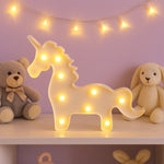 Unicorn LED decorative night light illuminated softly against dark background