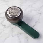 Side view of handheld lint remover