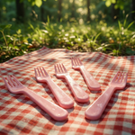 Pink plastic fork spoon with an innovative shape.