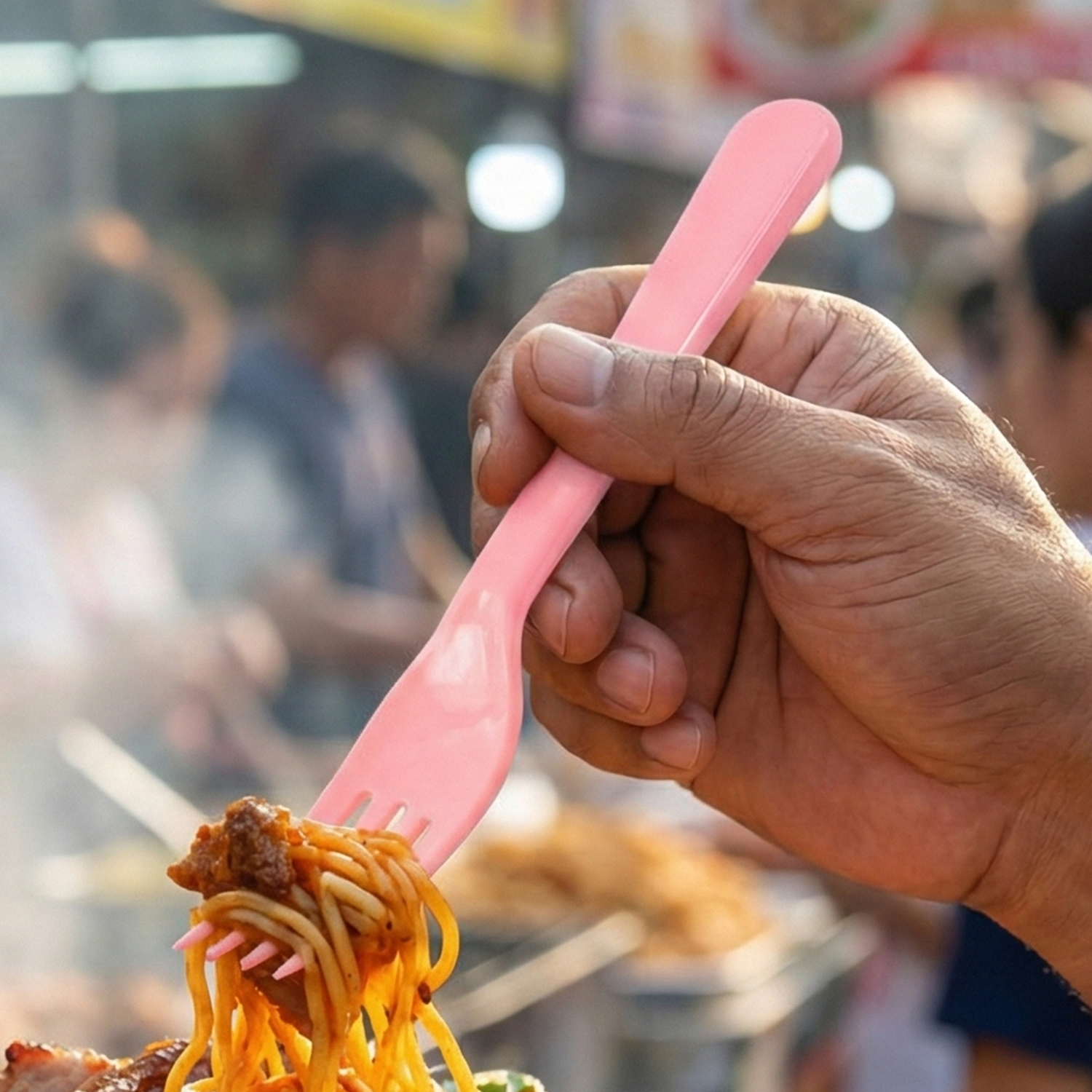 Ergonomic design of the pink plastic fork spoon.