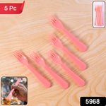 Close-up of a single pink plastic fork spoon.