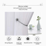Magnetic curtain holdback with its two magnetic balls snapped together.
