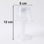 Small crystal table lamp creating a warm, ambient glow in a dark room.