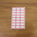 Close-up showing multiple sheets of blank writable self-adhesive shipping label stickers