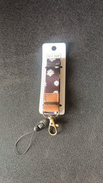 Close-up of floral print fabric neck lanyard with leather patch
