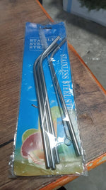 Hand holding a glass with an eco-friendly bent stainless steel straw, promoting sustainable living in India.
