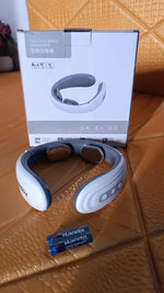 Compact electric neck and back massager device in use
