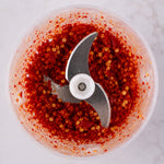 Chili inside stainless steel blade of garlic chopper